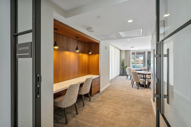 office space with baseboards, visible vents, and built in study area