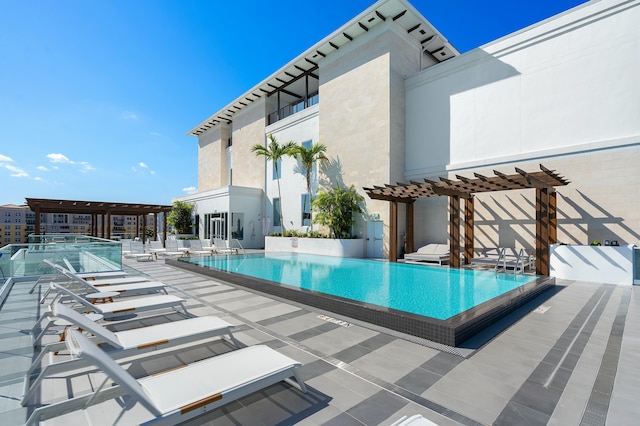 pool with a pergola and a patio area