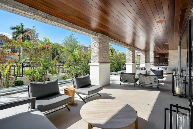 view of patio with an outdoor living space and fence