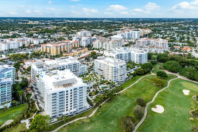 birds eye view of property featuring view of golf course and a view of city