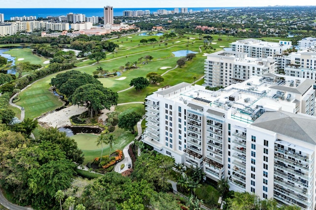 bird's eye view with view of golf course, a city view, and a water view