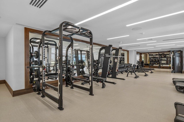 gym with baseboards, visible vents, and carpet