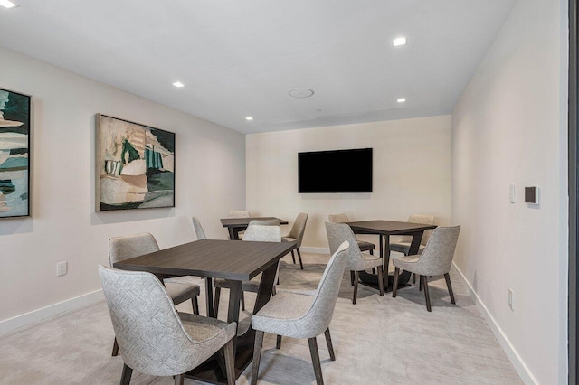 dining space featuring light colored carpet, baseboards, and recessed lighting