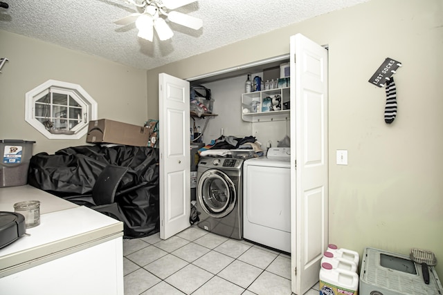 clothes washing area featuring independent washer and dryer, a textured ceiling, light tile patterned floors, and ceiling fan