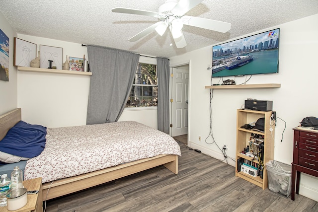 bedroom with wood-type flooring, a textured ceiling, and ceiling fan