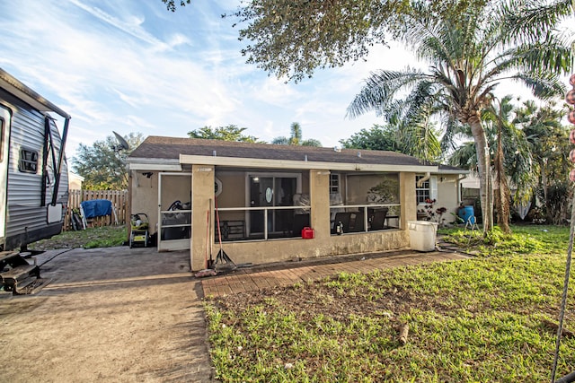 rear view of house featuring a sunroom