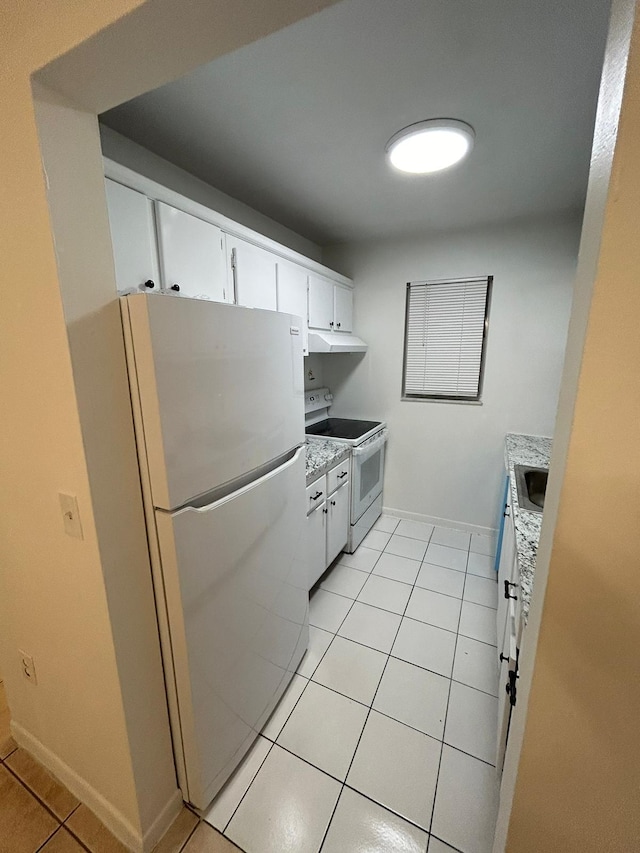 kitchen with sink, white cabinets, light tile patterned flooring, and white appliances