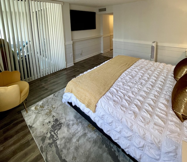 bedroom with dark hardwood / wood-style floors