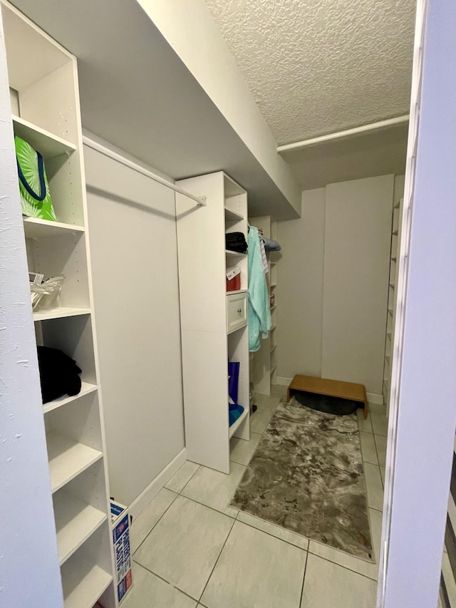 spacious closet featuring light tile patterned floors