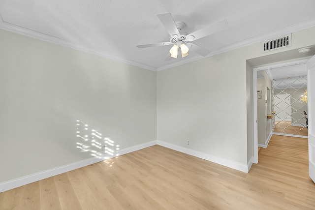 empty room featuring a textured ceiling, light wood-type flooring, ceiling fan, and ornamental molding