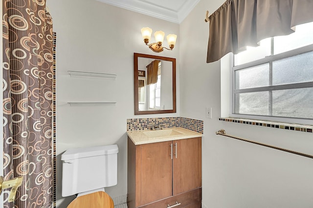 bathroom with vanity, backsplash, toilet, and crown molding