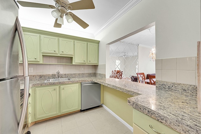 kitchen featuring kitchen peninsula, ornamental molding, stainless steel appliances, sink, and green cabinetry