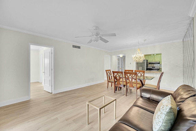 living room with ceiling fan with notable chandelier, light hardwood / wood-style floors, and ornamental molding