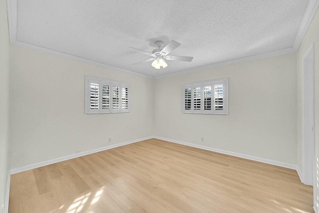 empty room featuring a textured ceiling, light hardwood / wood-style flooring, plenty of natural light, and crown molding