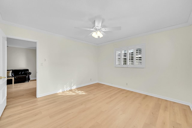 spare room with light wood-type flooring and crown molding