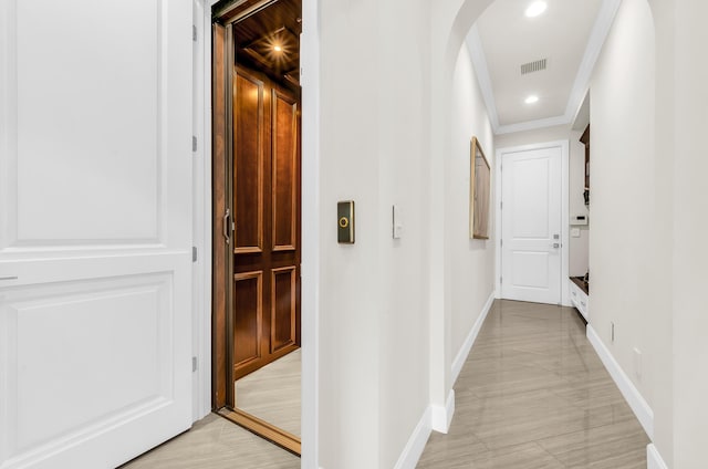 doorway with a water view and light hardwood / wood-style flooring