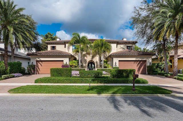 mediterranean / spanish home featuring a garage