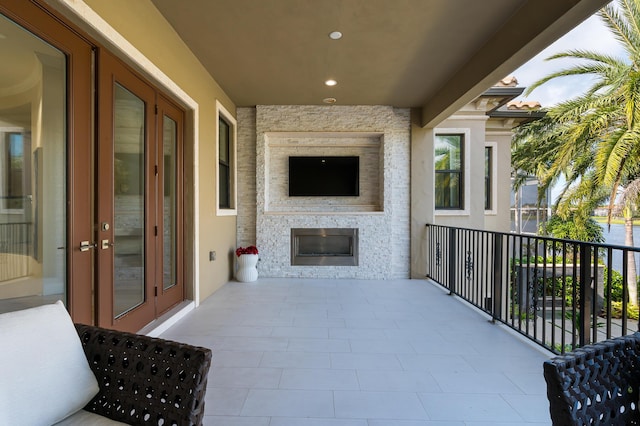 living room featuring wood-type flooring, a water view, crown molding, and wood ceiling