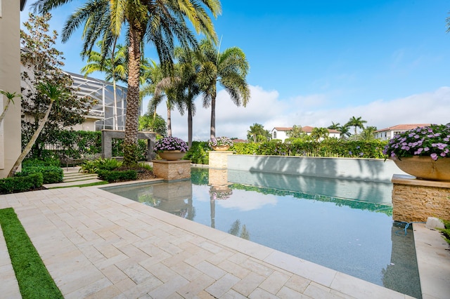 back of property featuring a patio area, outdoor lounge area, a balcony, and a hot tub