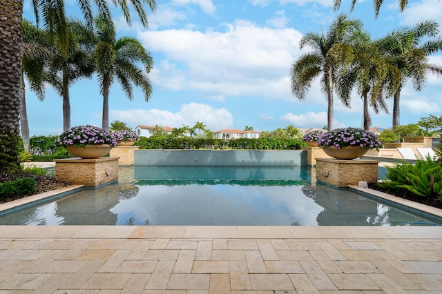 view of swimming pool featuring a water view