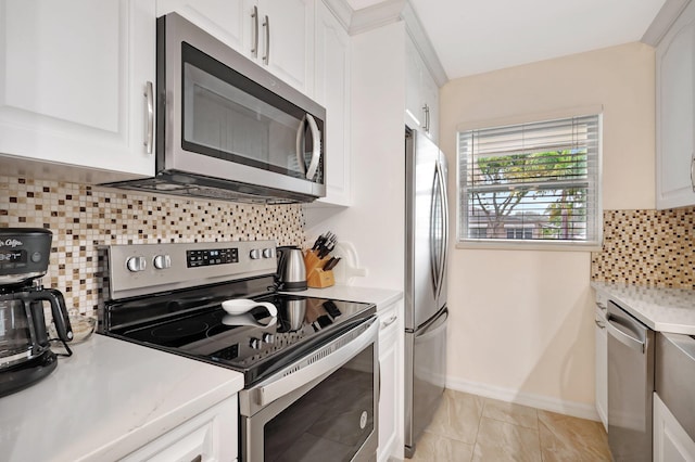 kitchen with backsplash, stainless steel appliances, white cabinetry, and light tile patterned flooring