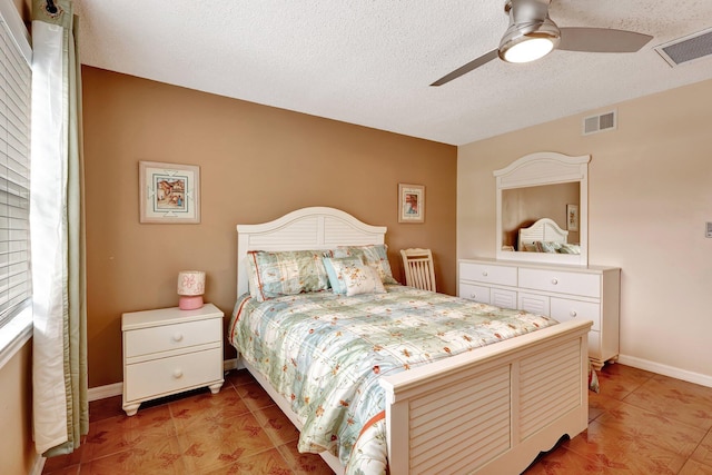 bedroom featuring a textured ceiling and ceiling fan