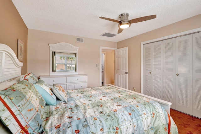 bedroom with parquet flooring, a textured ceiling, a closet, and ceiling fan