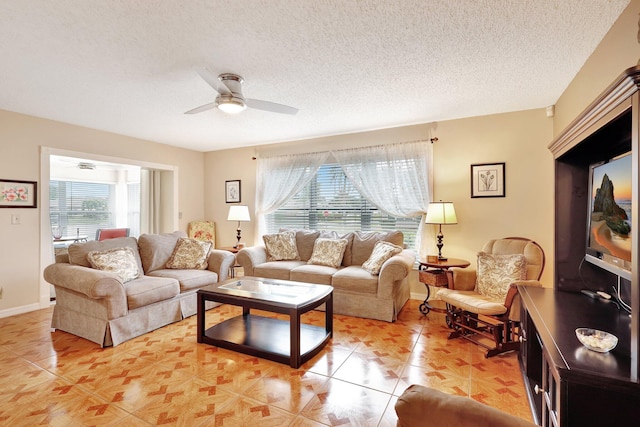 living room with ceiling fan and a textured ceiling