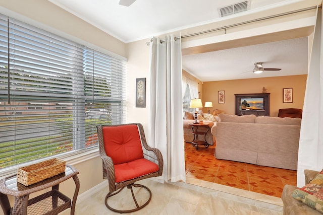 living area with ceiling fan and light tile patterned floors