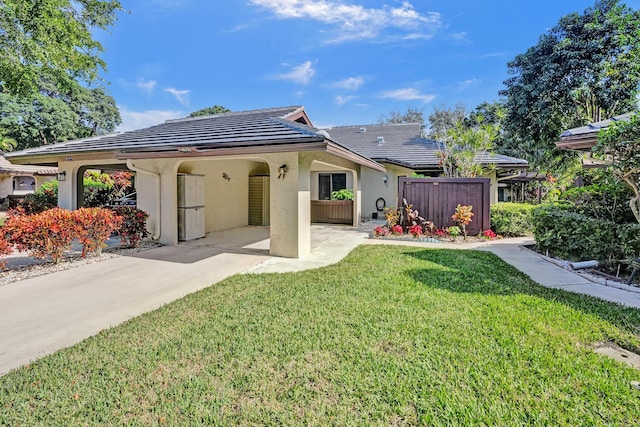 back of property featuring a yard and a carport