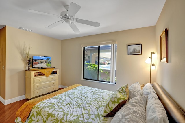 bedroom with ceiling fan and light hardwood / wood-style flooring