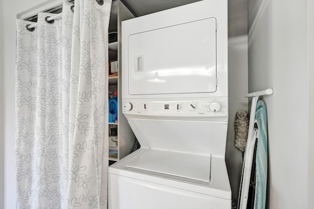 laundry room with stacked washer / drying machine