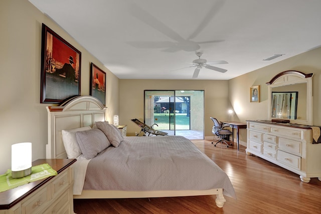 bedroom featuring access to exterior, ceiling fan, and hardwood / wood-style flooring