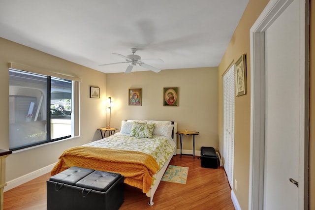 bedroom with ceiling fan, light hardwood / wood-style flooring, and a closet