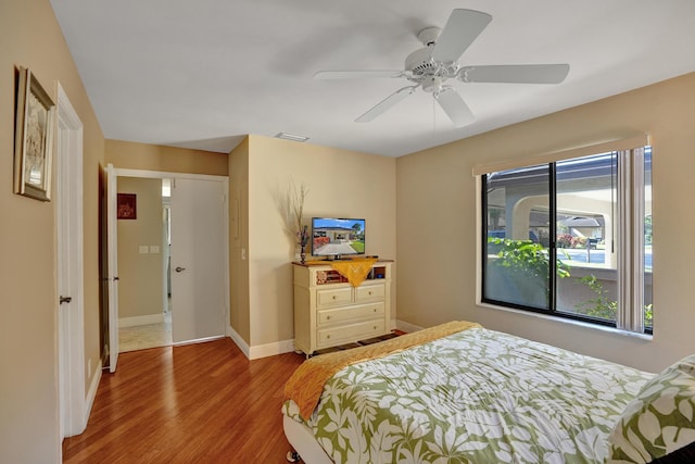 bedroom with a closet, ceiling fan, and light hardwood / wood-style floors