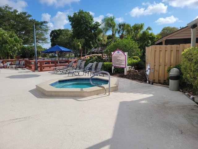 view of pool with a patio area and a hot tub