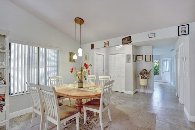 dining room with vaulted ceiling and a healthy amount of sunlight