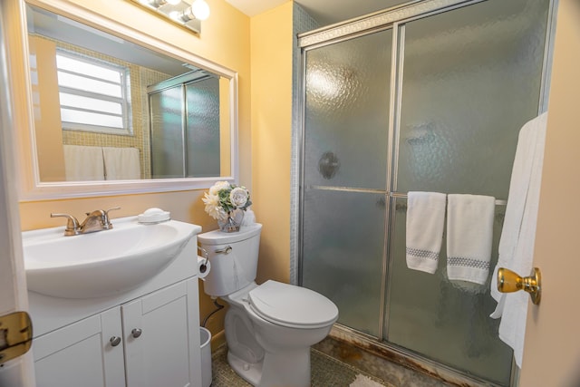 bathroom featuring vanity, toilet, and an enclosed shower