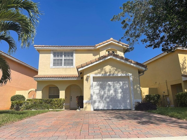 mediterranean / spanish-style home featuring a garage