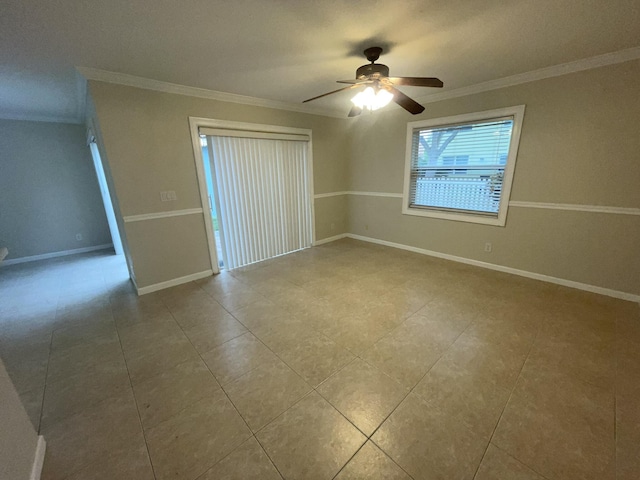 unfurnished room with ceiling fan and crown molding