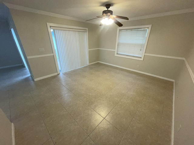 empty room with ceiling fan and crown molding