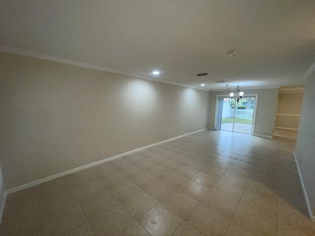 unfurnished room featuring a chandelier and crown molding