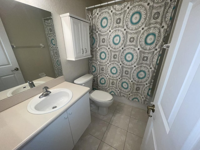 full bathroom with toilet, shower / tub combo, vanity, and tile patterned floors