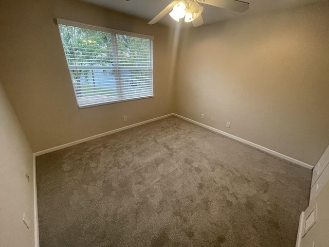 empty room with carpet flooring and ceiling fan