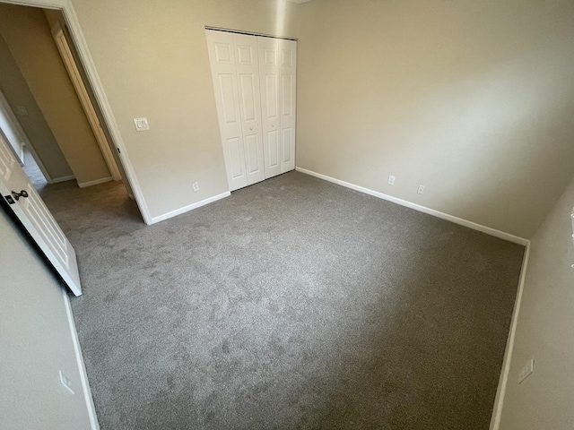 unfurnished bedroom with carpet floors and a closet