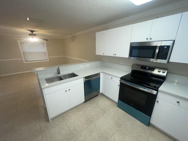 kitchen with kitchen peninsula, sink, white cabinets, and appliances with stainless steel finishes