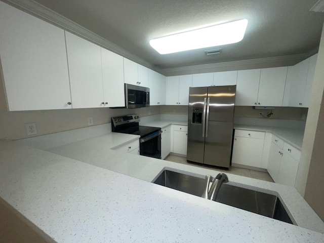 kitchen featuring light stone countertops, appliances with stainless steel finishes, ornamental molding, sink, and white cabinets