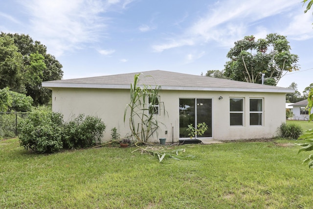 back of house featuring a lawn