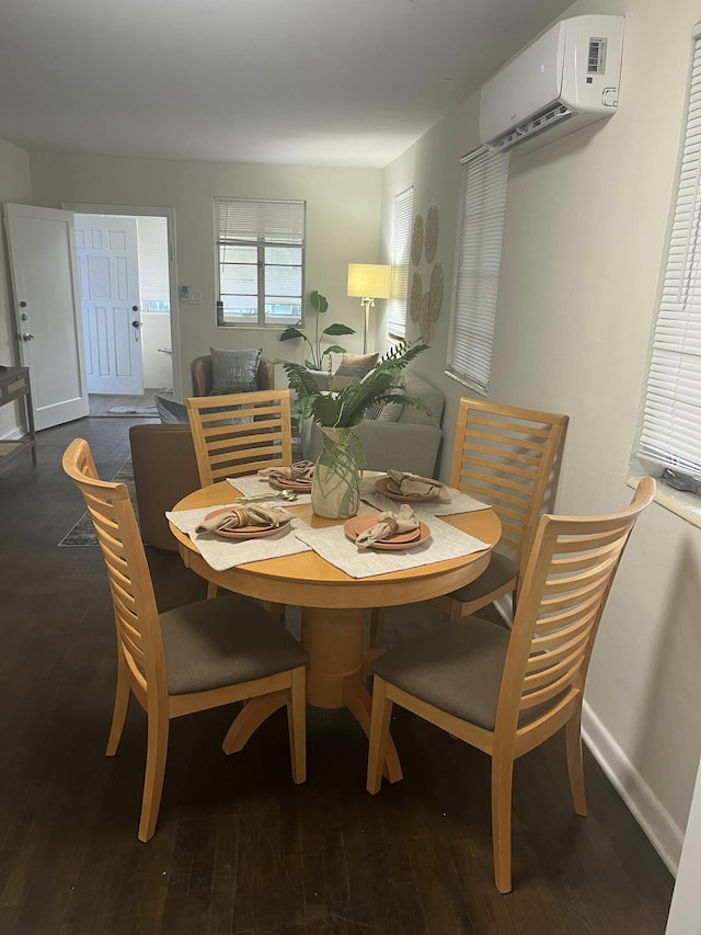 dining space featuring an AC wall unit and dark hardwood / wood-style flooring