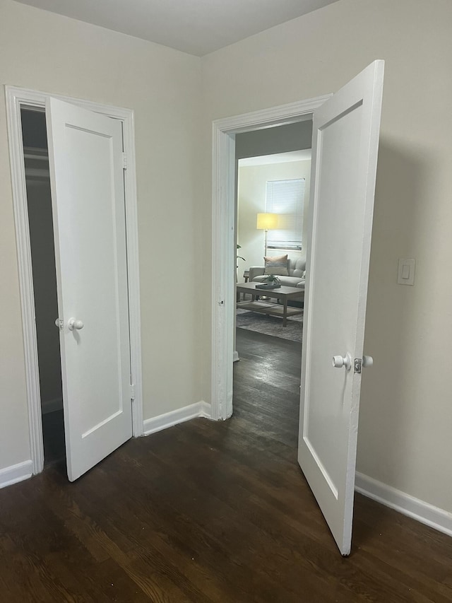 corridor with dark hardwood / wood-style floors